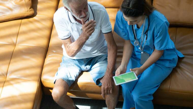 Doctor nurse female woman health care treatment patient male elderly senior hospital living room